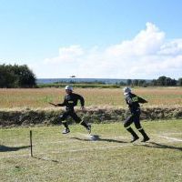 Przekazanie zmiany w sztafecie strażackiej na zawodach w Kozłowie